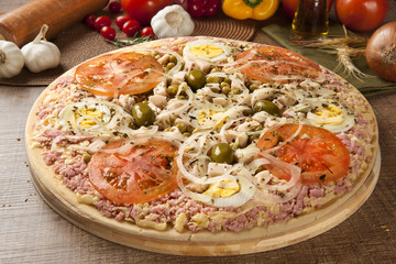 Raw pizza portuguese on wooden background