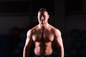 Fototapeta na wymiar Young handsome muscular man bodybuilder posing
