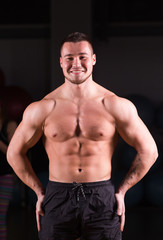 Obraz na płótnie Canvas Young handsome muscular man bodybuilder posing