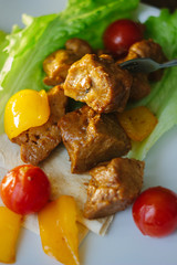 Seitan on white plate with the vegetables