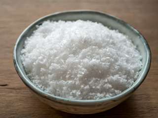 Fototapeta na wymiar Sea salt in bowl on wooden table