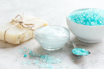 Obraz na płótnie Canvas spa composition with blue sea salt and natural soap on stone desk background