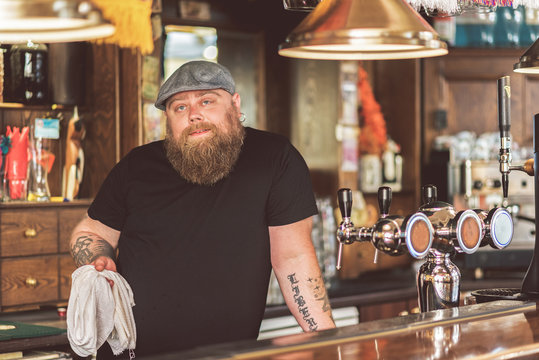 Tattooed male working as bartender
