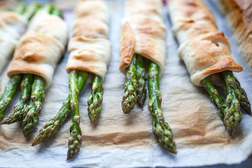New season for fresh asparagus has just started, roasted green fresh asparagus with parmesan in puff pastry