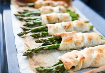 New season for fresh asparagus has just started, roasted green fresh asparagus with parmesan in puff pastry