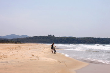 girl with bicycle on a sand shore
