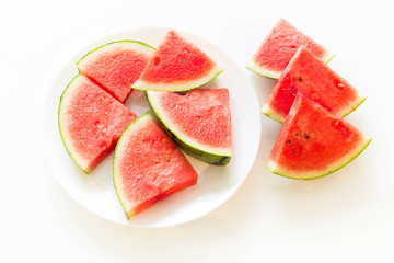 Juicy watermelon on a plate isolated on a white background.
