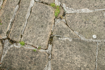 Old stone slabs of pavement surface closeup as background