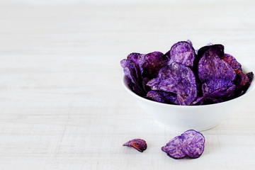 Purple potato chips in a bowl