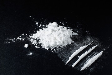 Heroin divided into paths on a black background - obrazy, fototapety, plakaty