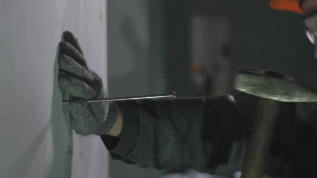 Skilled Worker in Gloves Nails Large Long Metal Spike