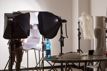 Photographic studio set up with assistant at work