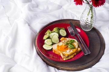 Fried eggs with toasts and tea in bed