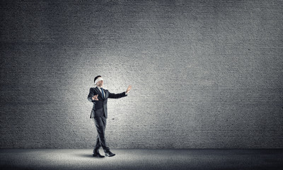 Business concept of risk with businessman wearing blindfold in empty concrete room