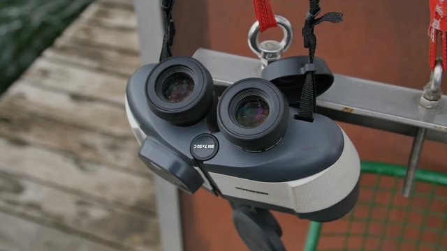 Binoculars is hanging on the wall of the fishing boat