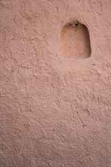 The wall is made of clay with a light box.