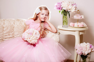 Blonde flower girl with peony bouquet and peony bouquets around her. Wedding. Trinity. Pentecost.