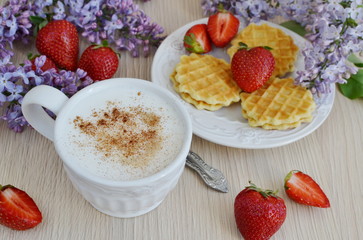  Cup of cappuccino with waffles, strawberries and flowers