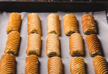 Homemade sweet cookies on a baking sheet. Front view