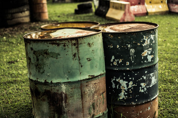 Obraz premium Metal old barrels isolated outdoor over green grass background