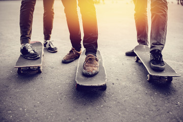 Group of friends skateboarders rest on the street and skateboard, shoes in holes and scuffs....