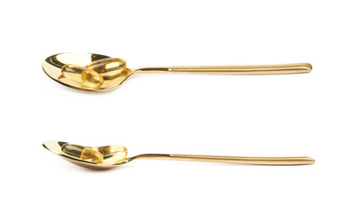 Metal spoon full of softgel pills