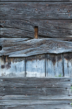 Close-up texture fragment of aged wooden board with cracked planks