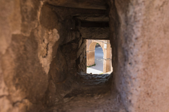 View of the ancient arch through the embrasure in the wall of the fortress