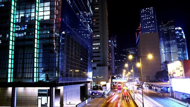 Hong Kong City Night Timelapse. 4K Wide Shot. Corporate Buildings And Busy Traffic At Rush Hour.