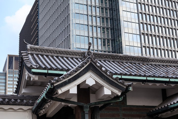 Tile ancient Japanese roofs against modern buildings in Tokyo city, Japan