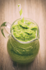 Rucola smoothie, on the grey  background.