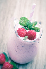 Raspberry milk shake with mint decor.