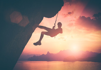 Climber against red sunset. Instagram stylisation