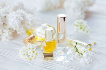 Obraz na płótnie Canvas Bottles of perfume with flowers