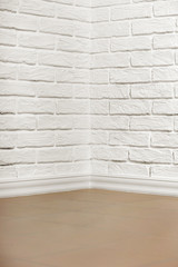 Fototapeta na wymiar white brick wall with tiled floor and corner, abstract background photo