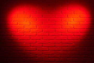 Fototapeta na wymiar dark red brick wall with heart shape light effect and shadow, abstract background photo