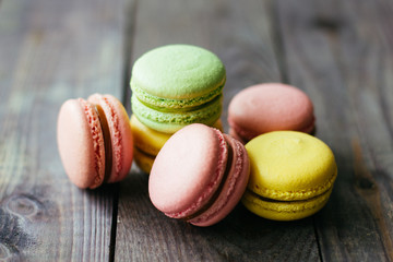 French almond dessert white macaroni on brown wooden table.