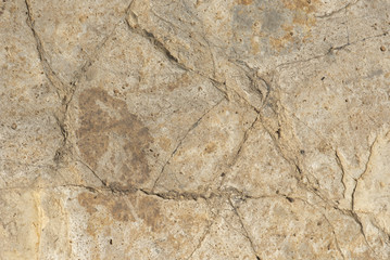 Brown stone with cracks, background or texture