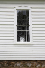 Old Grilled Window Pains and Wood Siding on Historic Little White Church