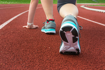 Athlete woman at starting line ready to run