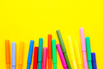 Fototapeta premium Art - colored pens on yellow background 