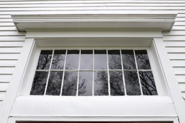Old White Exterior Window Frame with Grille Pains on Historic Little Church