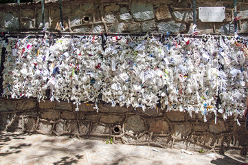 Wishing wall with tied note petitions to the Virgin Mary saint and Mother of God at her restored house near Ephesus Turkey