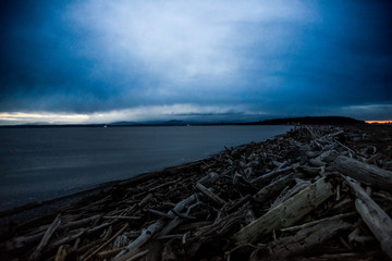 Dramatic Dark Cloud Movement Develop Over Keystone Beach Washington Where The Ocean Shore Pile With Drift Woods On A Very Cold Winter Sunset