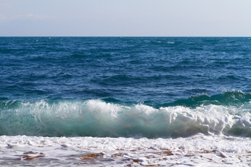 Natural sea wave with foam near seashore, nature backdrop