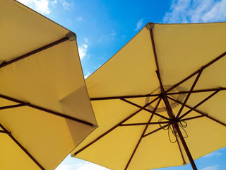 Under view from yellow umbrella with clearly sky background