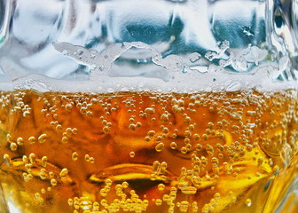 beer with bubbles and foam close up background