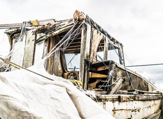 Abandoned boat covered in a tarp