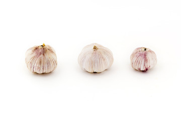 Three fresh Young bulbs of garlic neatly isolated on white background