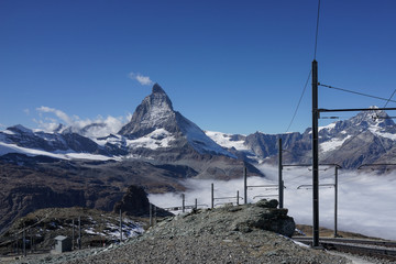 Beautiful iconic mountain Matterhorn with with railway and mist below Zermatt, Switzerland